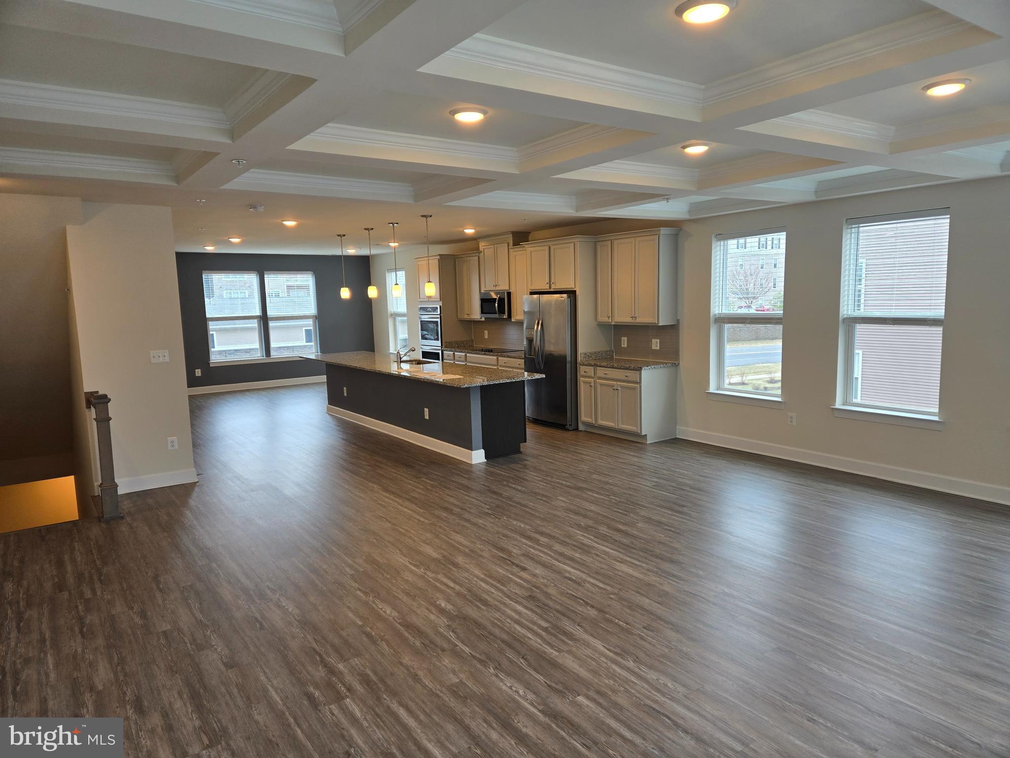 7635 Stemhart Lane Hanover, MD 21076 - Photo 3 of 28 a view of a living room a kitchen and a wooden floor