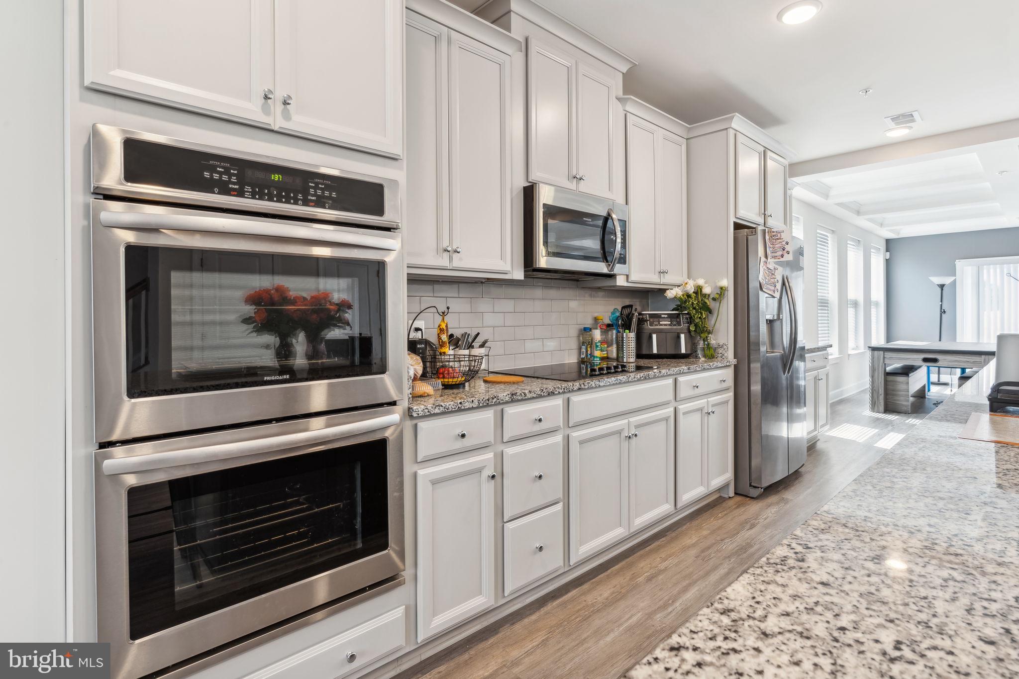 7635 Stemhart Lane Hanover, MD 21076 - Photo 7 of 28 a kitchen with stainless steel appliances white cabinets and stove