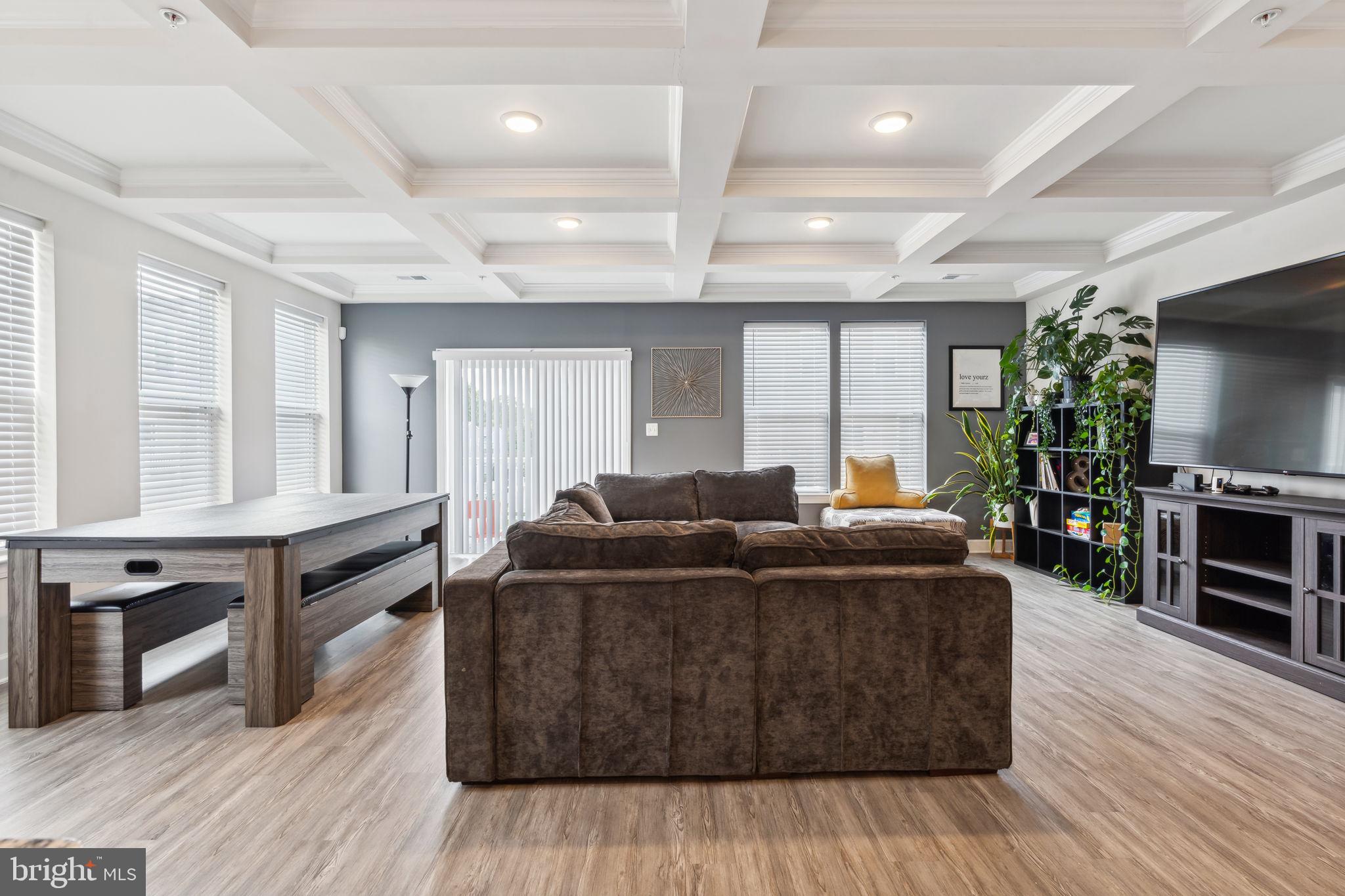 7635 Stemhart Lane Hanover, MD 21076 - Photo 9 of 28 a living room with furniture windows and a flat screen tv
