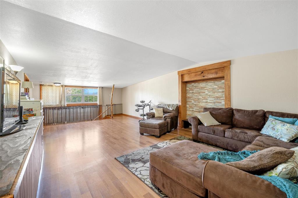 311 Cedar Ridge Drive China Spring, TX 76633 - Photo 11 of 28 Living room with light vinyl wood-style flooring and lofted ceiling