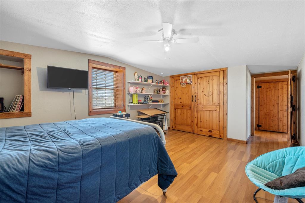311 Cedar Ridge Drive China Spring, TX 76633 - Photo 14 of 28 Bedroom featuring vaulted ceiling, light wood-type flooring, a textured ceiling, and a ceiling fan