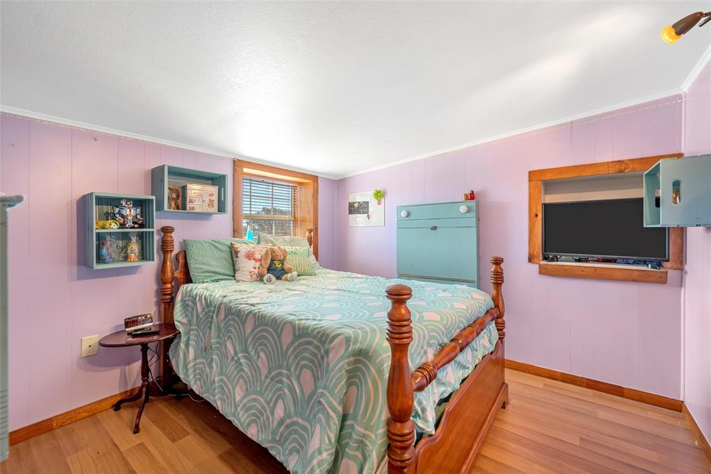 311 Cedar Ridge Drive China Spring, TX 76633 - Photo 16 of 28 Bedroom featuring wood finished floors and ornamental molding