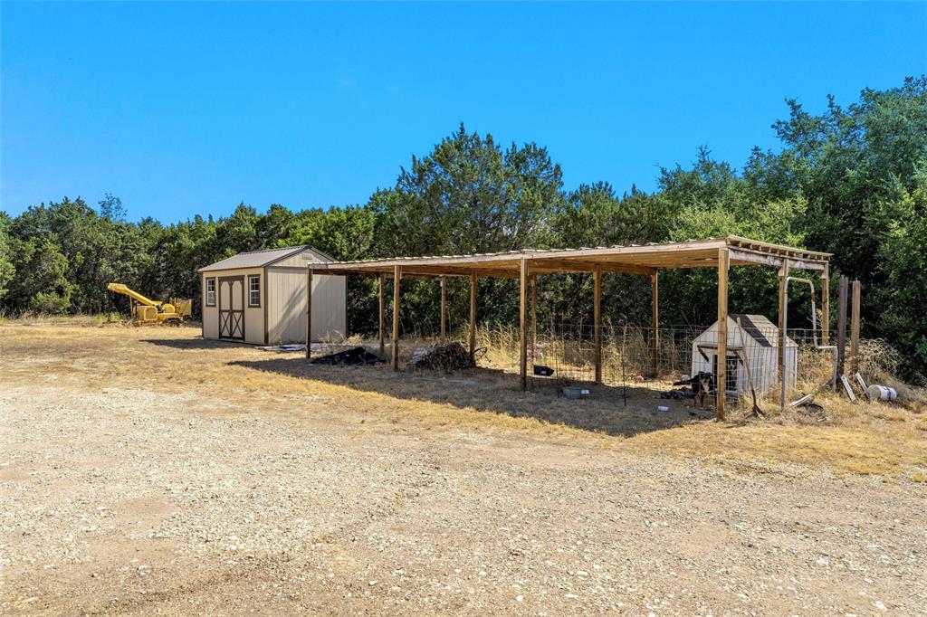311 Cedar Ridge Drive China Spring, TX 76633 - Photo 19 of 28 View of parking with a carport and a storage shed