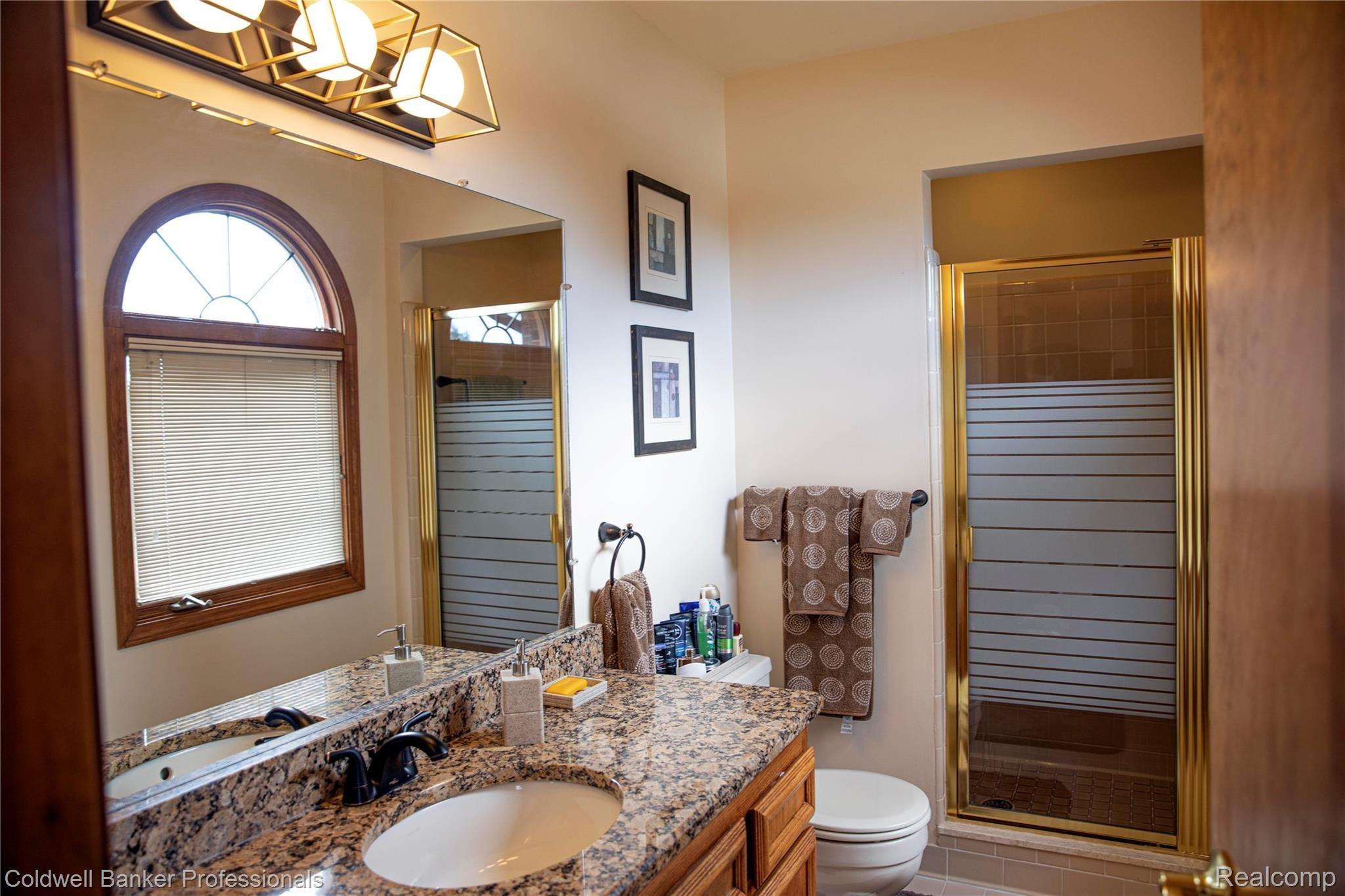 3216 Primrose Drive Rochester, MI 48307 - Photo 18 of 39 Updated master bath with granite and new shower door.