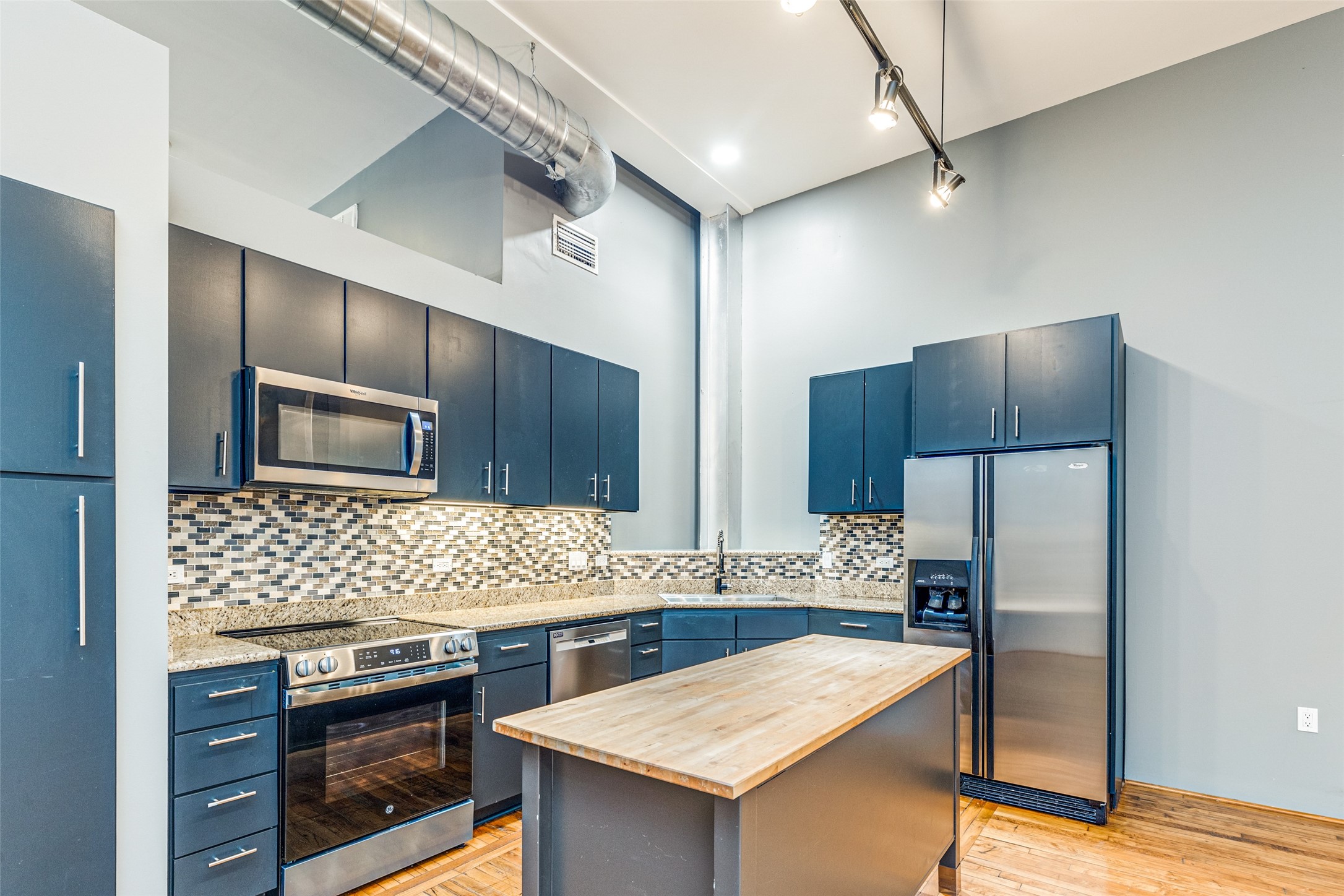 1312 Live Oak Street, Unit 223 Houston, TX 77003 - Photo 6 of 31 Modern kitchen with custom cabinetry, stainless steel appliances, and ample counter space.