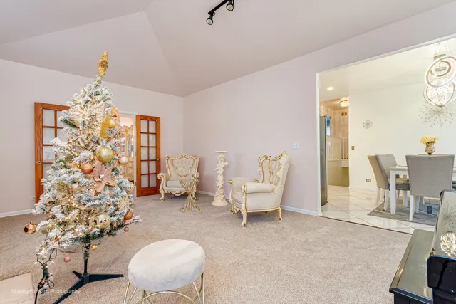a living room with furniture and a chandelier
