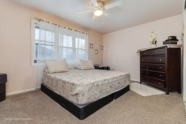 a bedroom with a bed and window