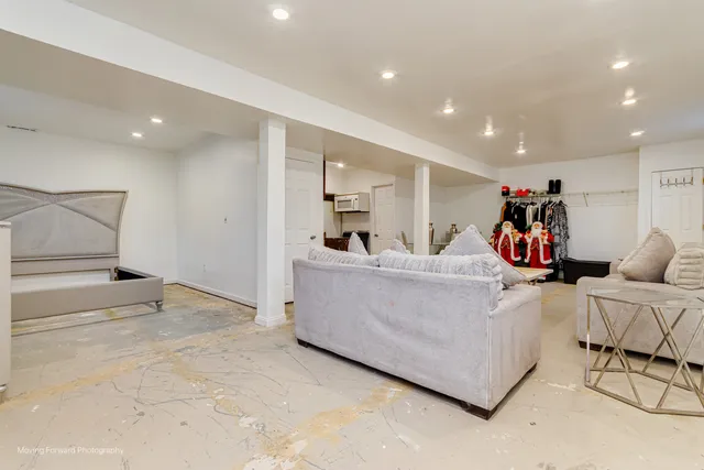 a living room with furniture and white cabinets