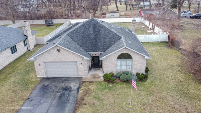 a aerial view of a house with a yard and plants