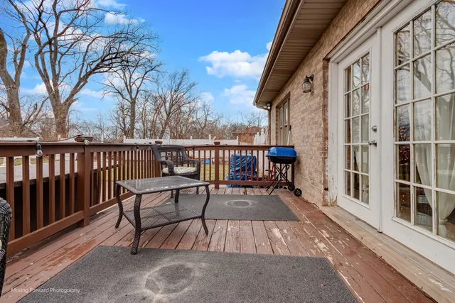 a view of a roof deck with wooden floor and fence