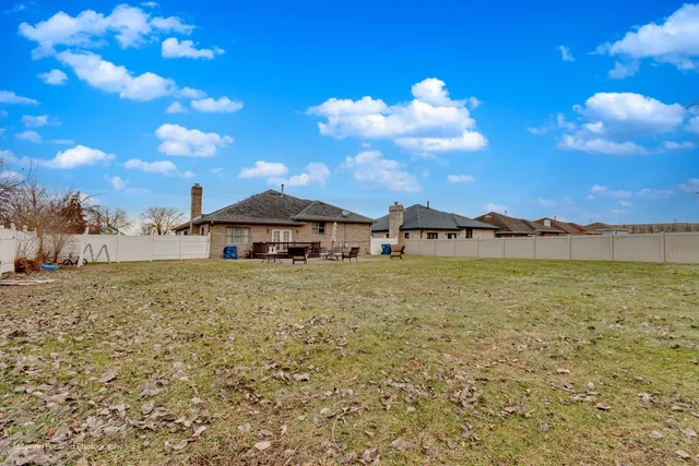 a view of a house with a yard and lake view