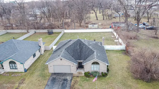 a view of a house with pool and a yard