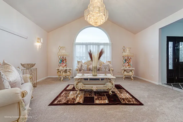 a living room with furniture chandelier and a table