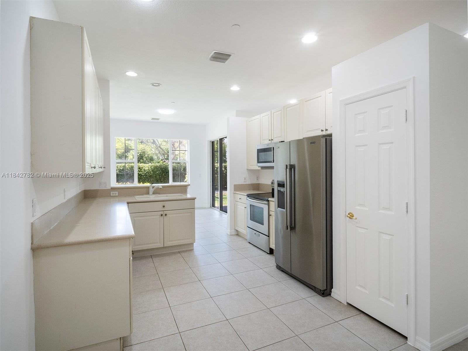 43 Lancaster Road Boynton Beach, FL 33426 - Photo 11 of 29 a kitchen with a refrigerator and a sink