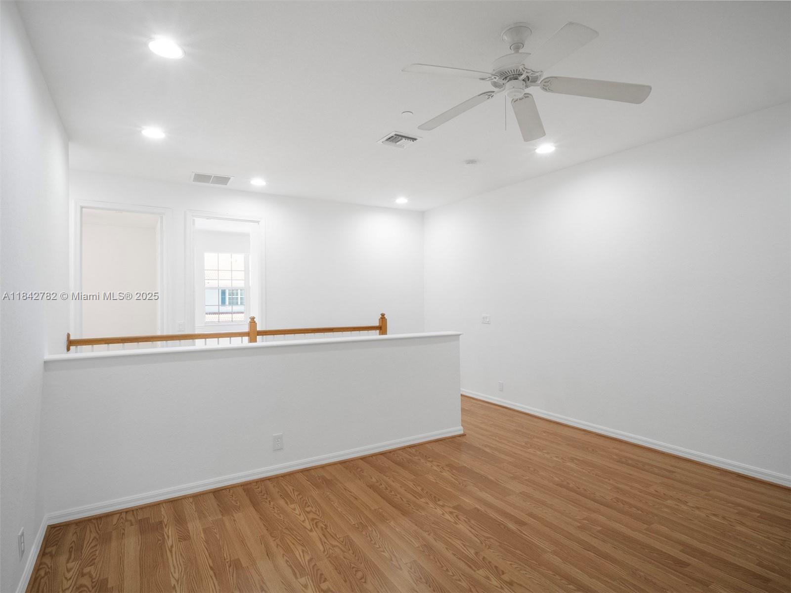 43 Lancaster Road Boynton Beach, FL 33426 - Photo 12 of 29 an empty room with wooden floor and fan
