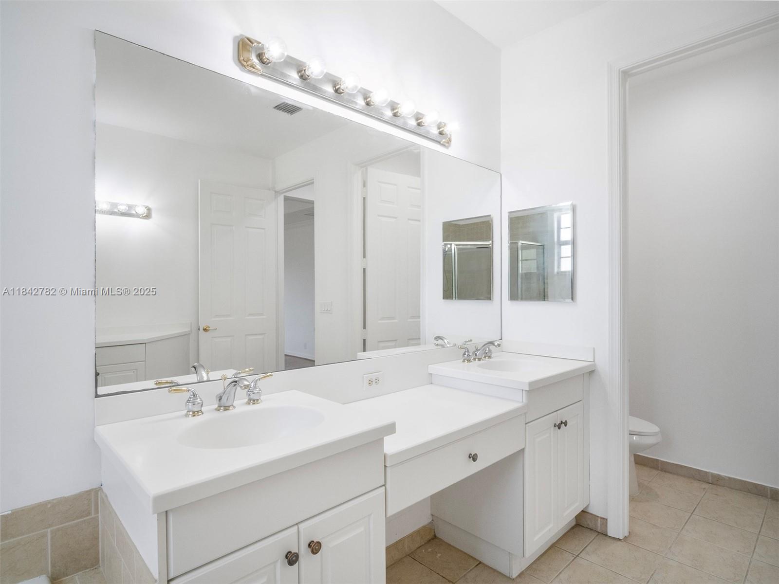43 Lancaster Road Boynton Beach, FL 33426 - Photo 16 of 29 a bathroom with a sink and a mirror