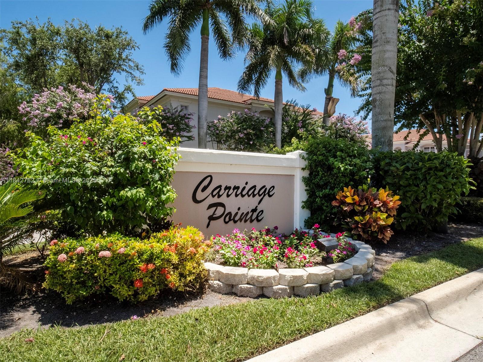 43 Lancaster Road Boynton Beach, FL 33426 - Photo 2 of 29 a sign that is in front of flowers