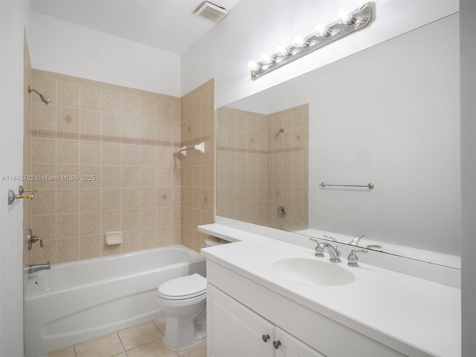 43 Lancaster Road Boynton Beach, FL 33426 - Photo 21 of 29 a bathroom with a bathtub shower sink vanity mirror and toilet