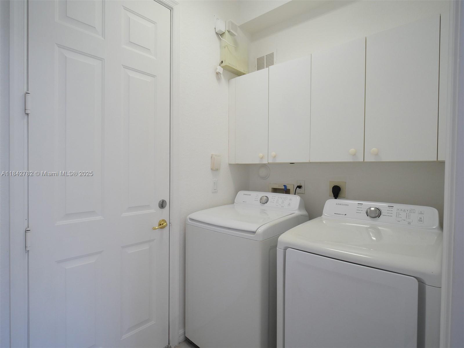 43 Lancaster Road Boynton Beach, FL 33426 - Photo 22 of 29 a view of storage and utility room with washer and dryer