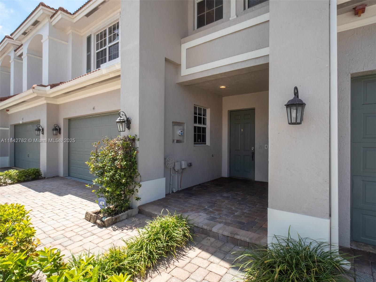 43 Lancaster Road Boynton Beach, FL 33426 - Photo 4 of 29 a view of a front of house with potted plants