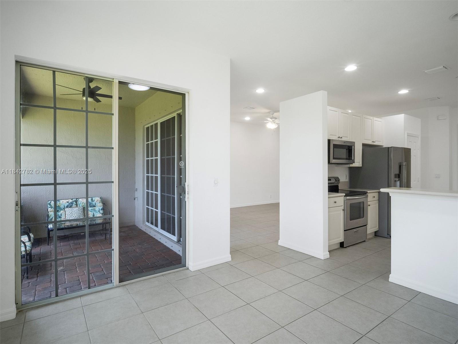 43 Lancaster Road Boynton Beach, FL 33426 - Photo 9 of 29 a view of kitchen with furniture and refrigerator