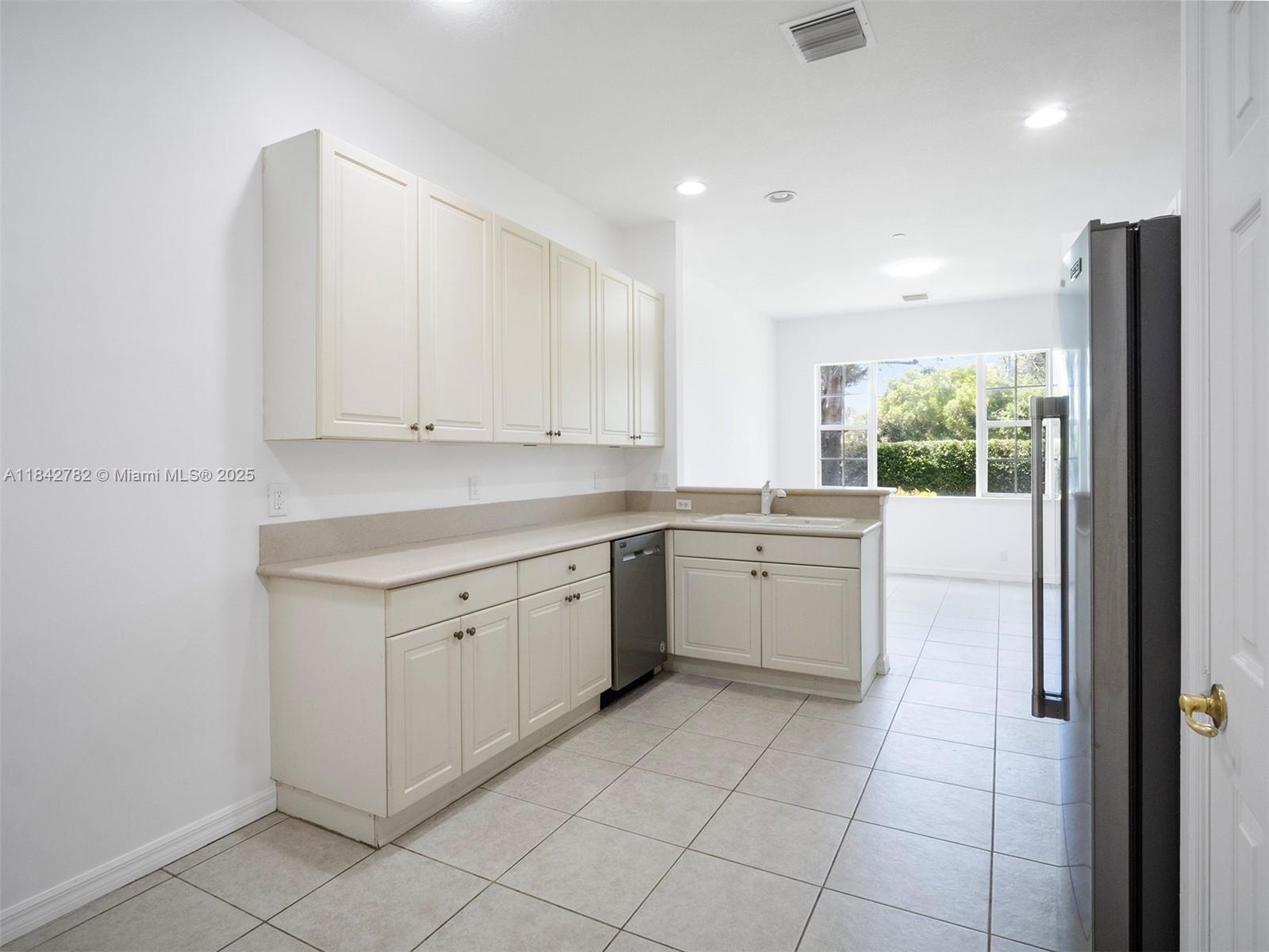 43 Lancaster Road Boynton Beach, FL 33426 - Photo 10 of 29 a kitchen with a stove a sink and a refrigerator