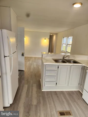 a room with wooden floor and cabinets