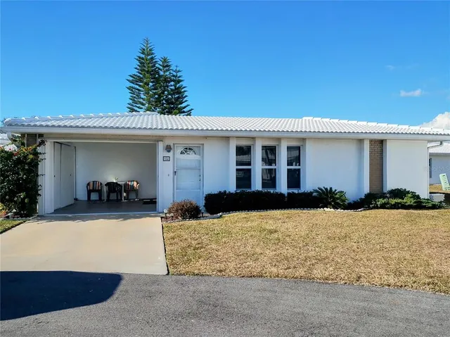 a living room with furniture a flat screen tv and a window