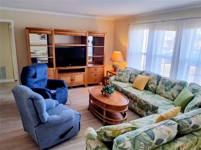 a living room with furniture dining table and wooden floor