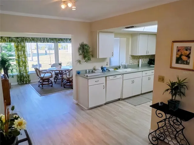 a kitchen with furniture a refrigerator and a stove