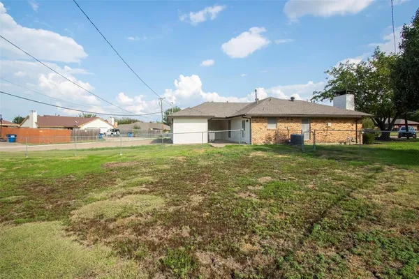 a view of a house with a yard and sitting area