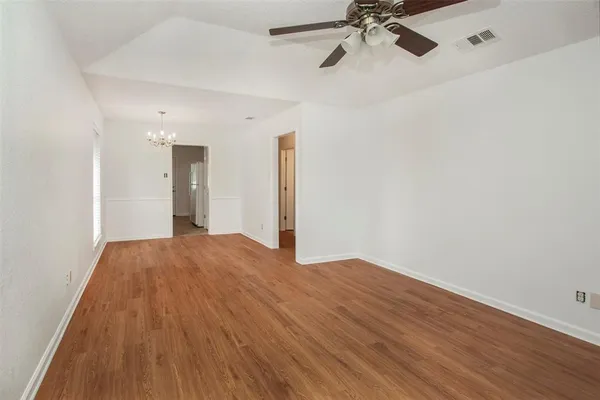 a view of an empty room and a ceiling fan