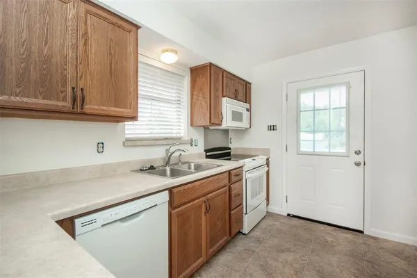 a kitchen with a sink cabinets and a window