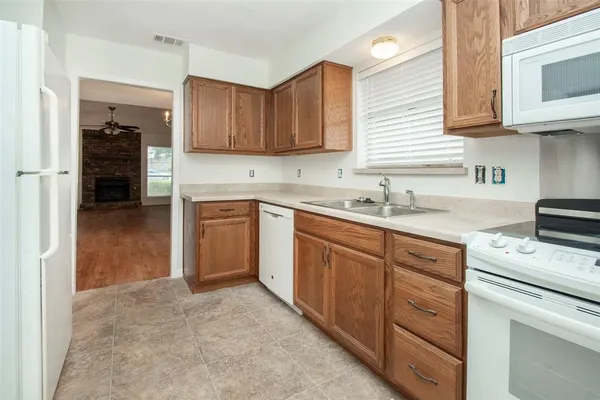 a kitchen with a sink stove and cabinets