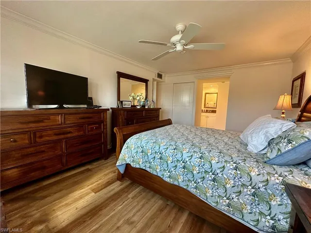 a bedroom with a bed and flat screen tv