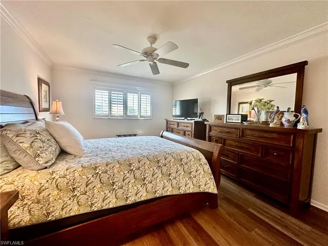 a bedroom with a bed and dresser with window