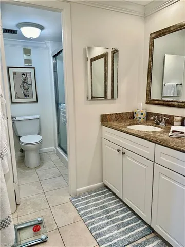 a spacious bathroom with a toilet sink and mirror