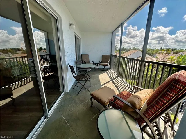 a view of a balcony with furniture