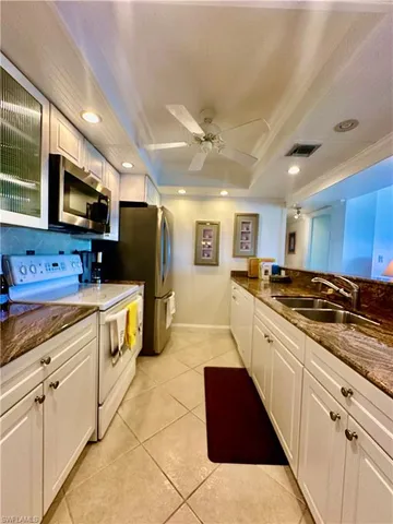 a large kitchen with stainless steel appliances and cabinets