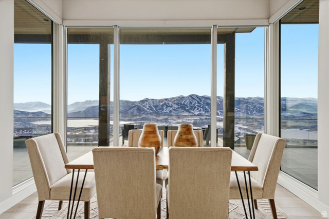 2002 East Outlaw Road Kamas, UT 84036 - Photo 29 of 65 Dining area with expansive floor-to-ceiling windows, engineered wood flooring, and a panoramic mountain and lake backdrop