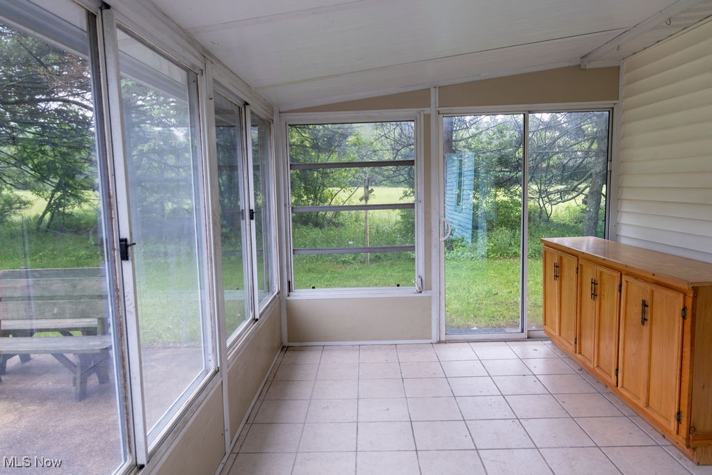 3333 Dayton Road Madison, OH 44057 - Photo 19 of 48 Unfurnished sunroom featuring lofted ceiling and tile patterned floors