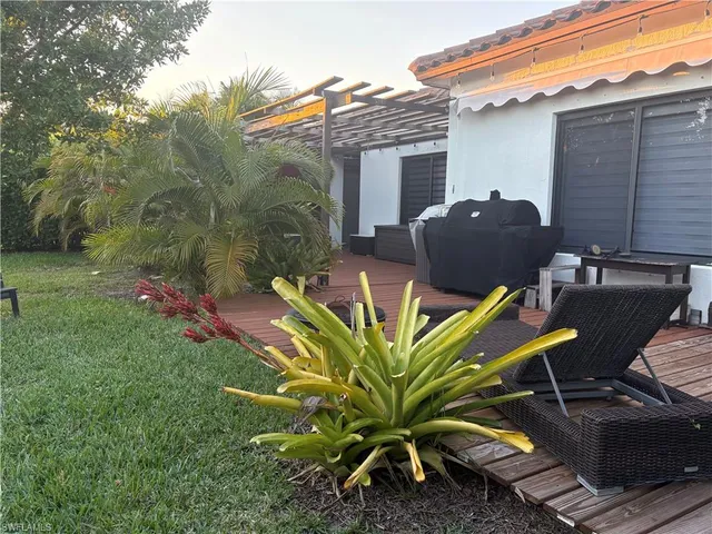 a view of backyard with outdoor seating and plants
