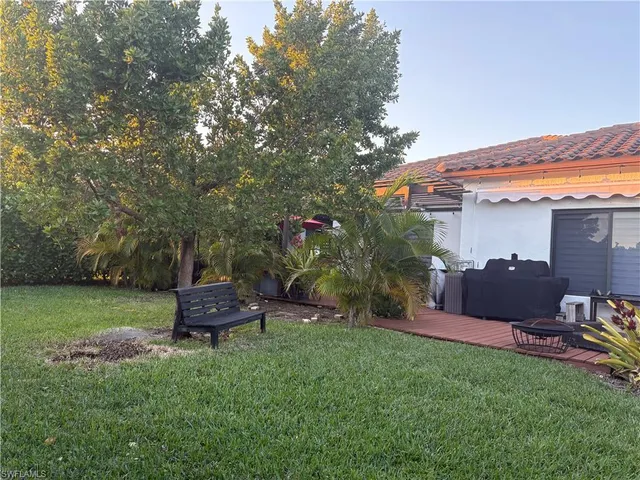 a view of a chair and table in the garden