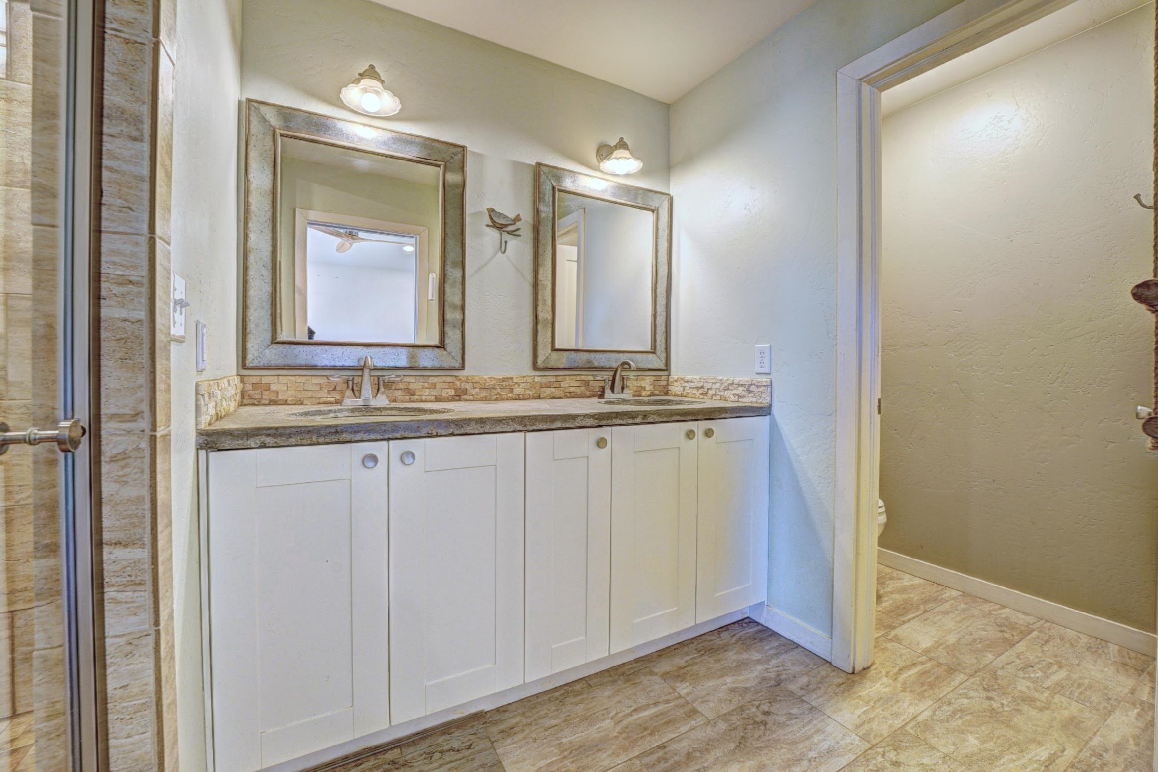 1570-45 45 1/2 Road De Beque, CO 81630 - Photo 12 of 35 a bathroom with a granite countertop sink and a mirror
