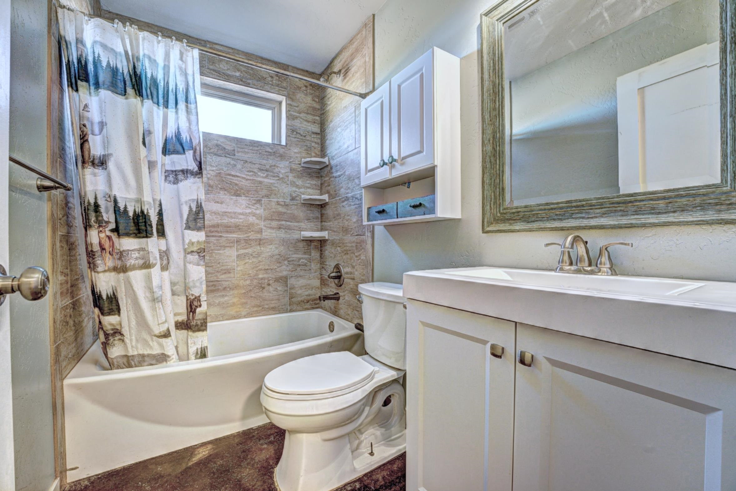 1570-45 45 1/2 Road De Beque, CO 81630 - Photo 21 of 35 a bathroom with a bathtub shower sink mirror vanity and toilet