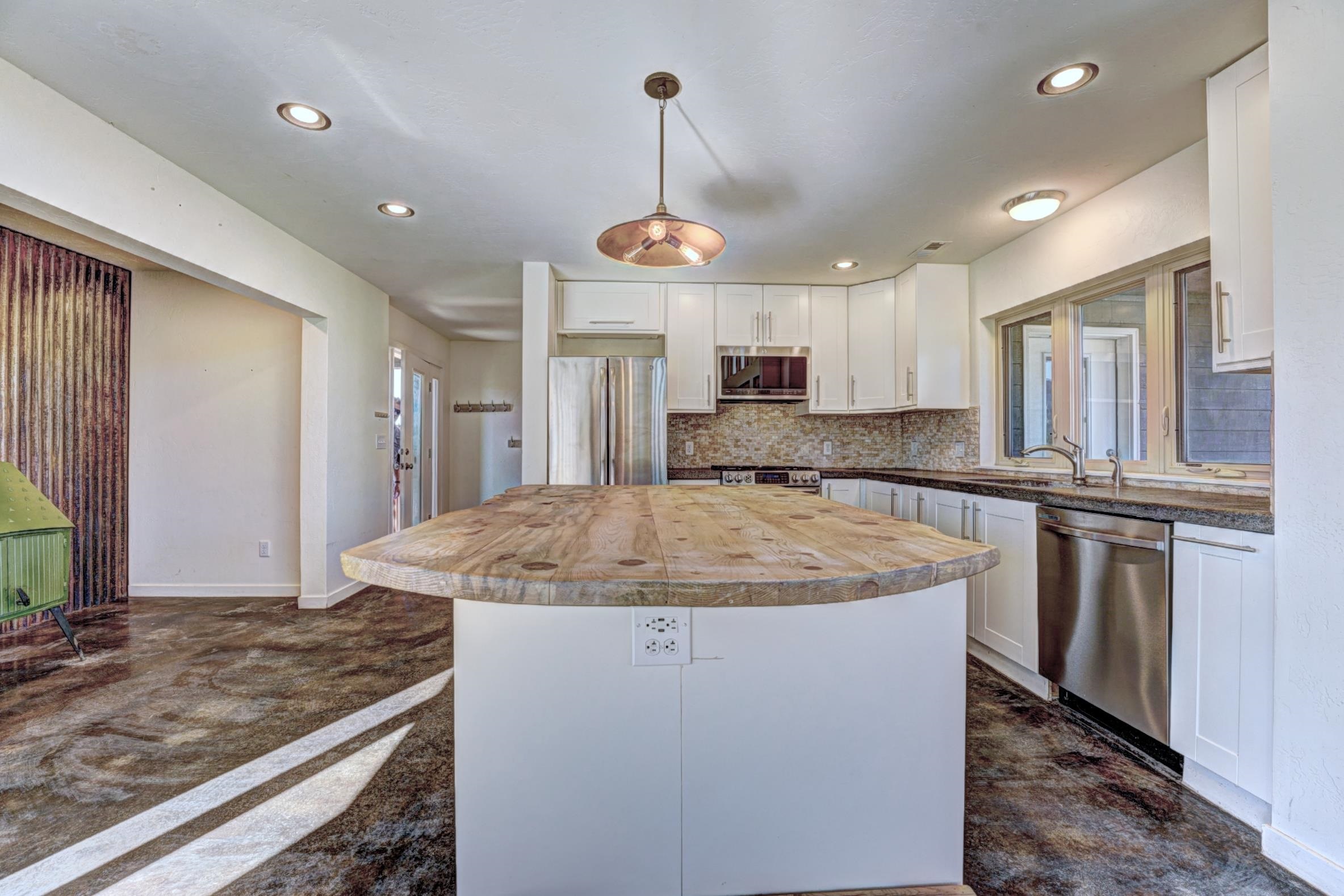 1570-45 45 1/2 Road De Beque, CO 81630 - Photo 7 of 35 a kitchen with stainless steel appliances granite countertop a sink a stove a refrigerator and cabinets