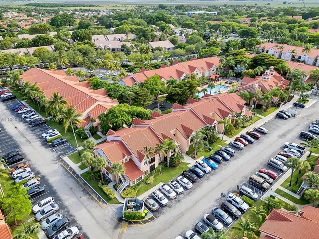 an aerial view of residential houses with outdoor space and street view