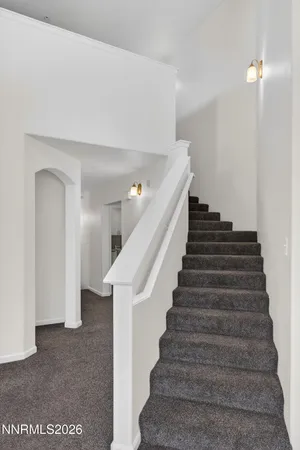 a view of a kitchen with a sink and an entryway