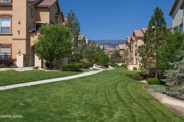 an aerial view of a house with a mountain
