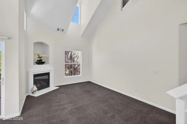 a view of an empty room with a fireplace